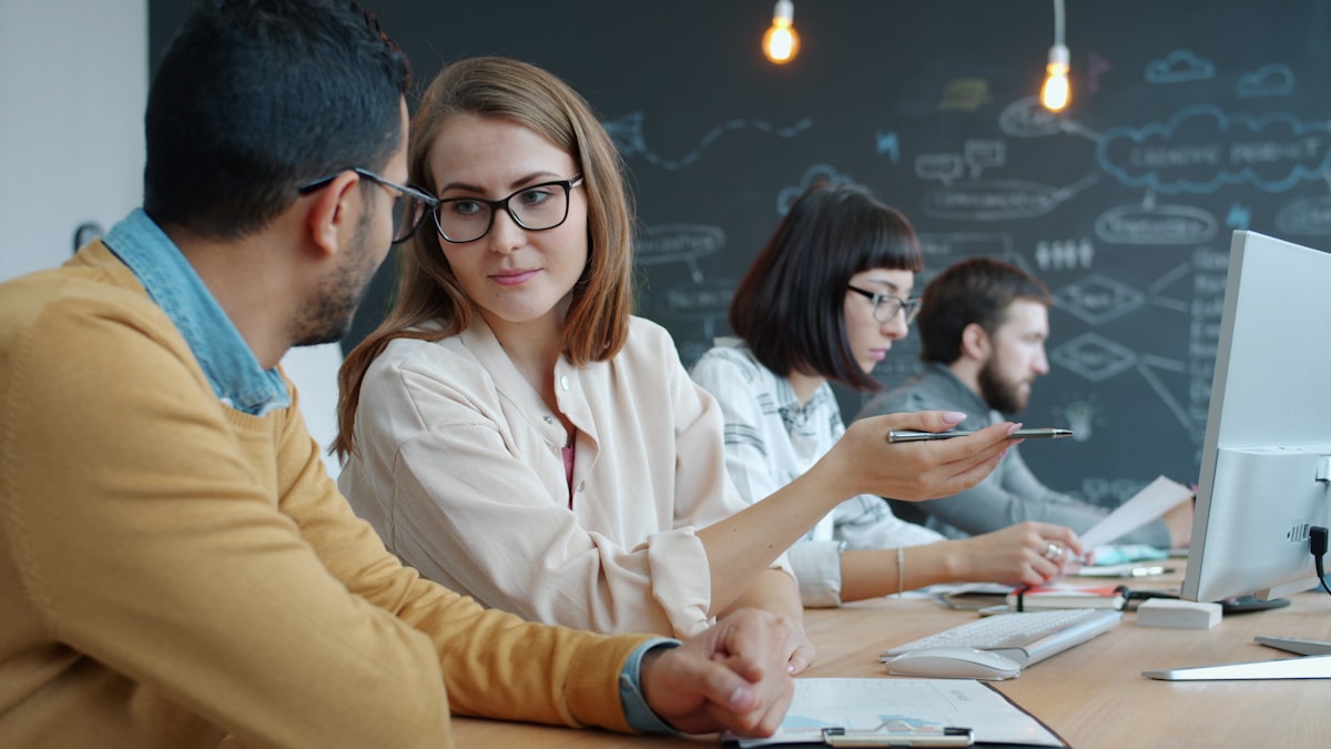 A small business team discussing work at a shared desk