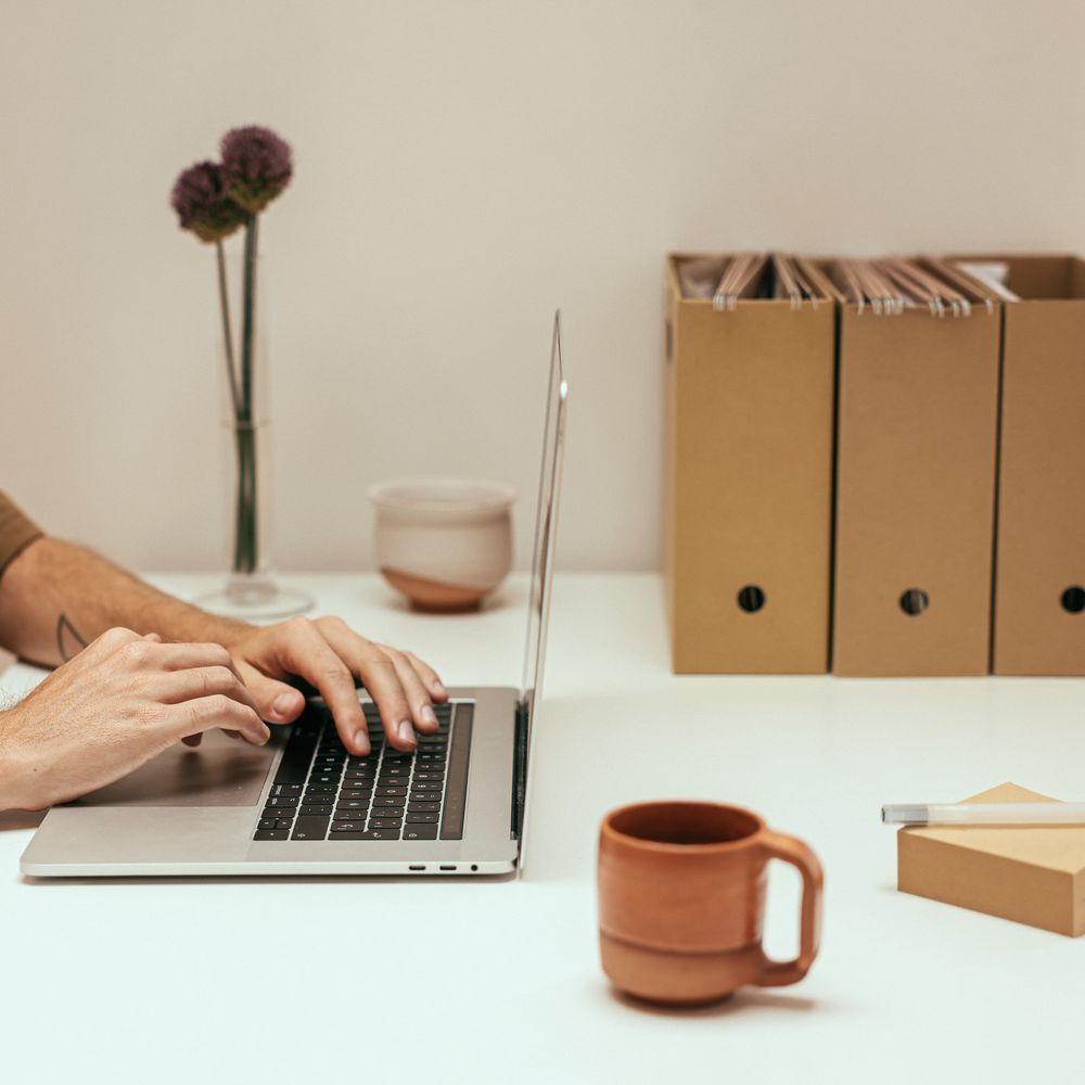 A clean, organized desk with a laptop, representing a well-managed everyday life